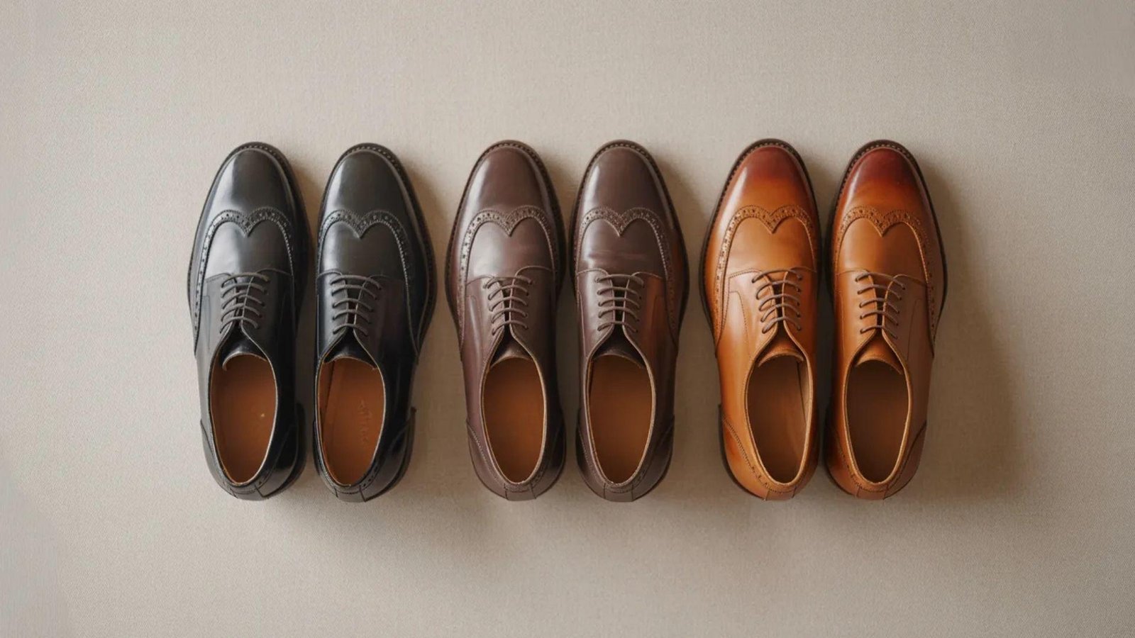 Four pairs of shoes displayed in various colors, showcasing a range of styles and designs.