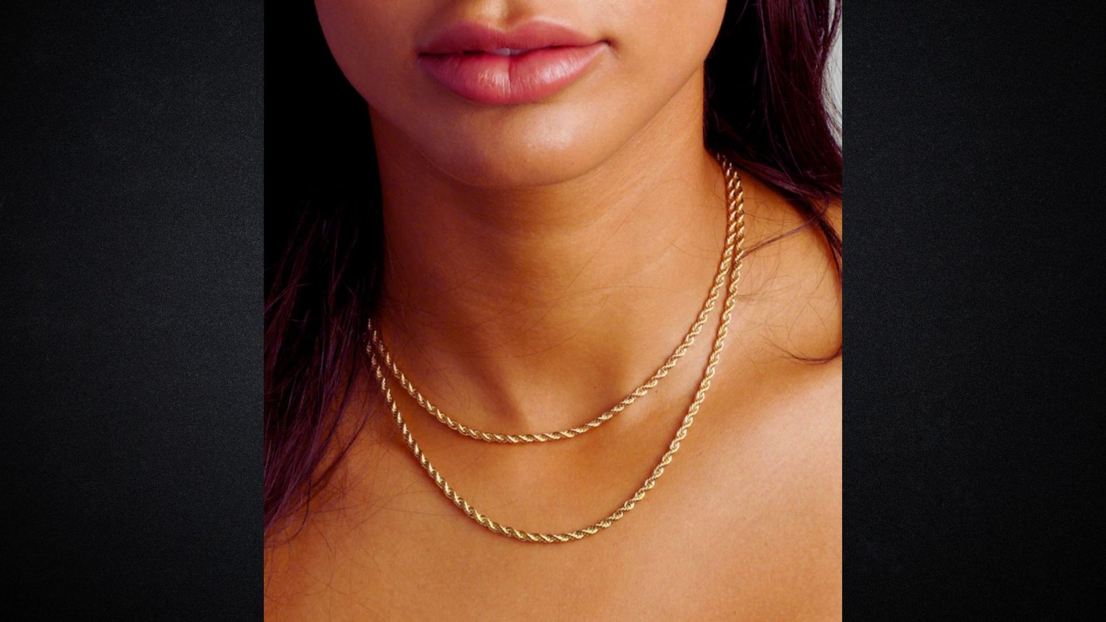 A woman wearing a gold chain around her neck, showcasing a stylish accessory.