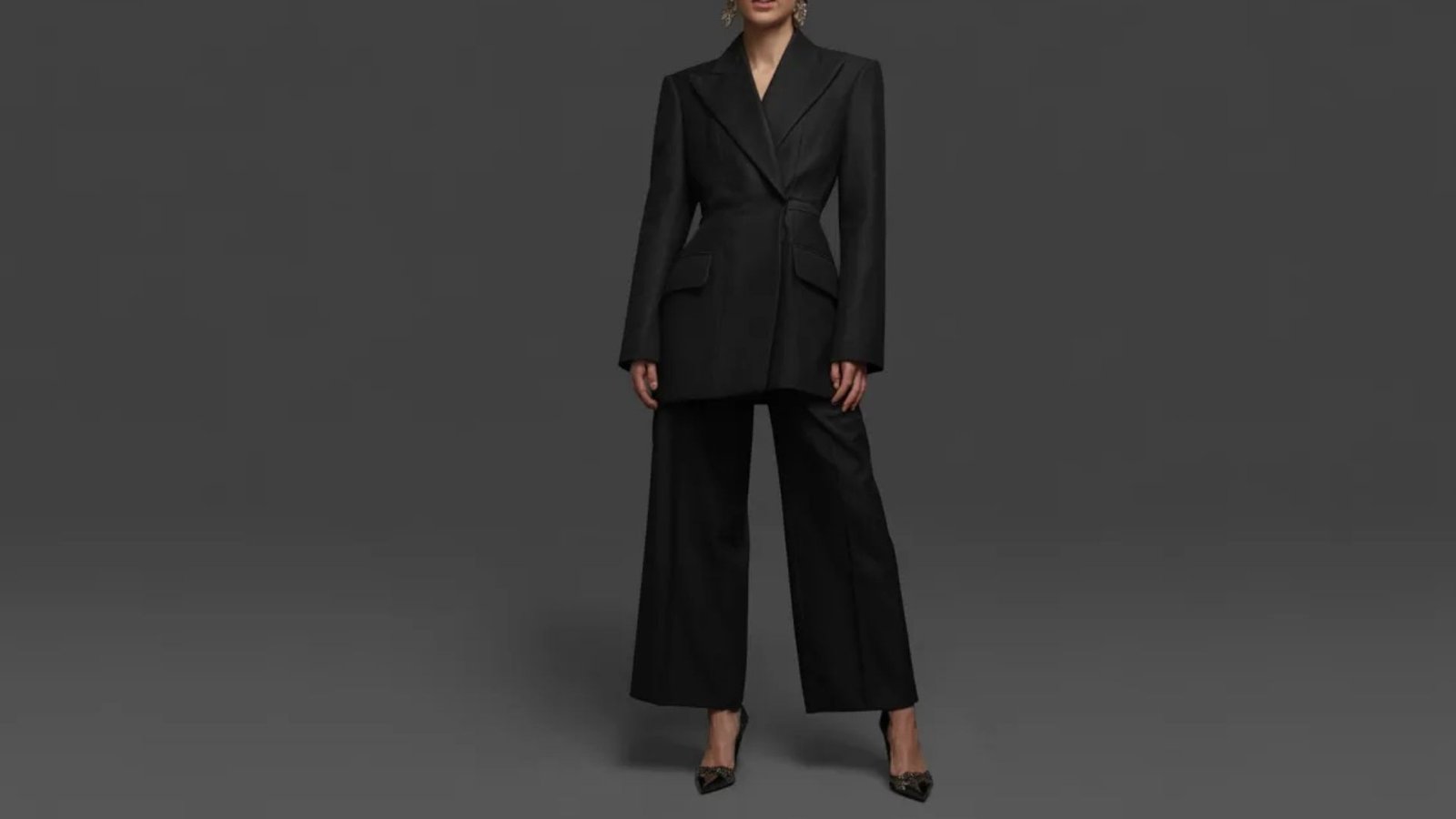 A sleek black suit displayed on a mannequin, showcasing its tailored design and modern style.