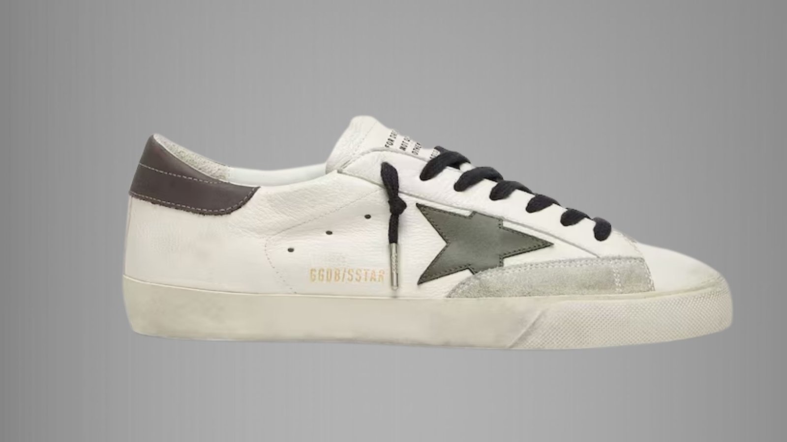 White Golden Goose sneakers with a distressed finish and star logo on the side, set against a neutral background.