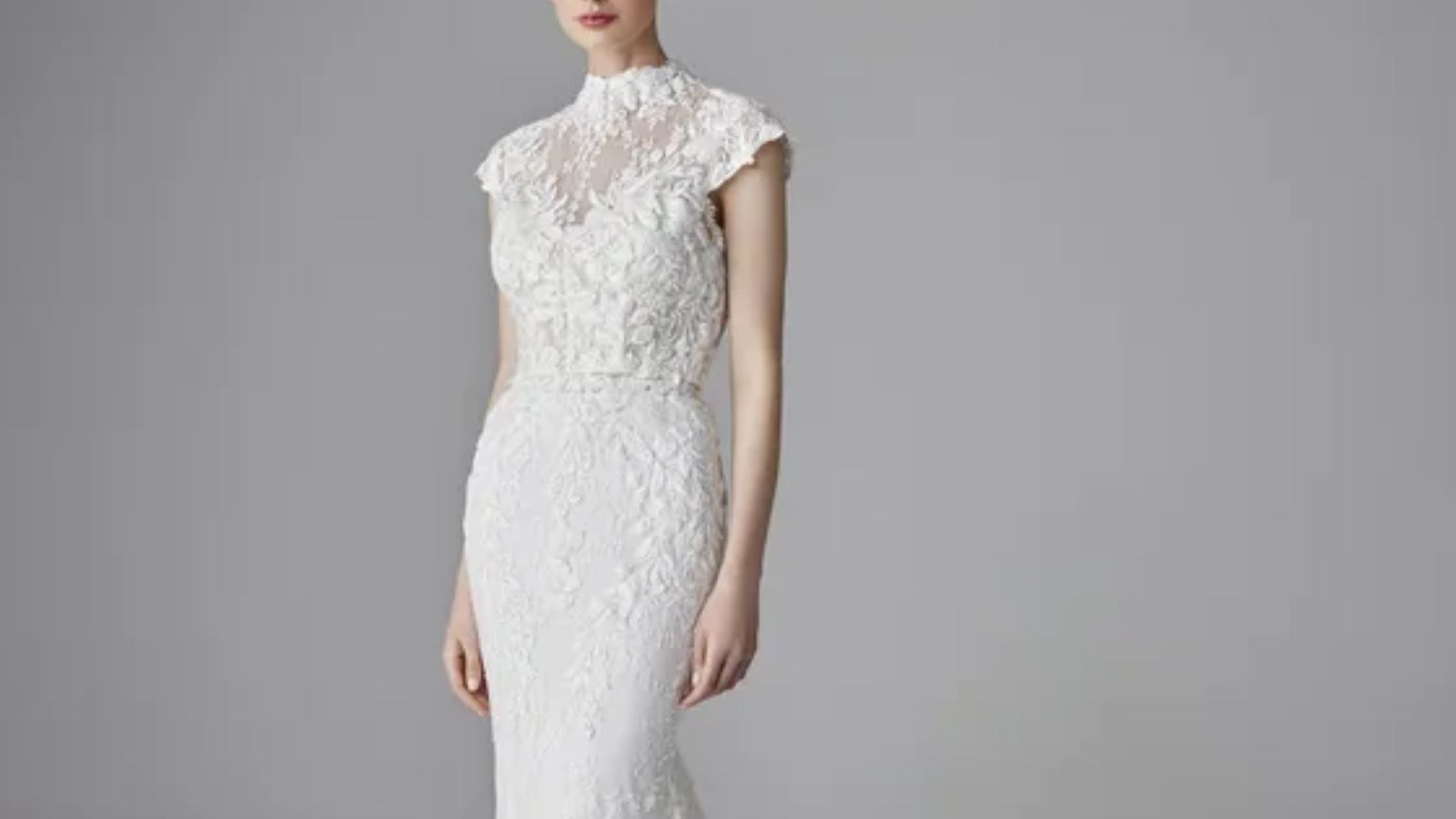 Elegant wedding dress from designer Jenny's collection, featuring intricate lace details and a flowing silhouette.