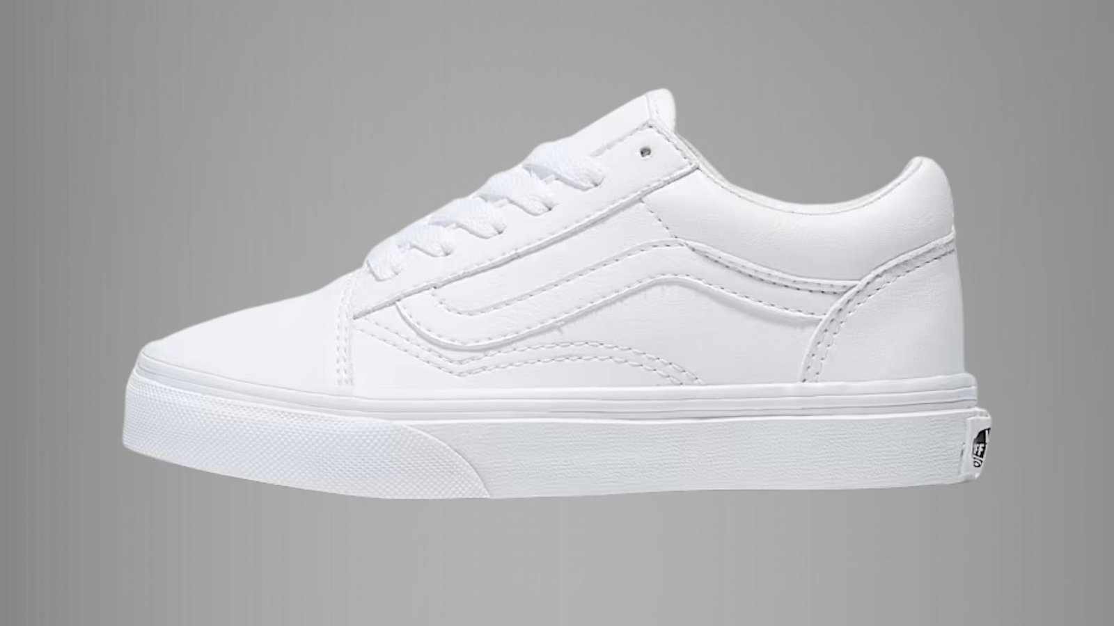 Classic white Vans Old Skool sneakers with black stripe and laces, showcasing a timeless skate style.