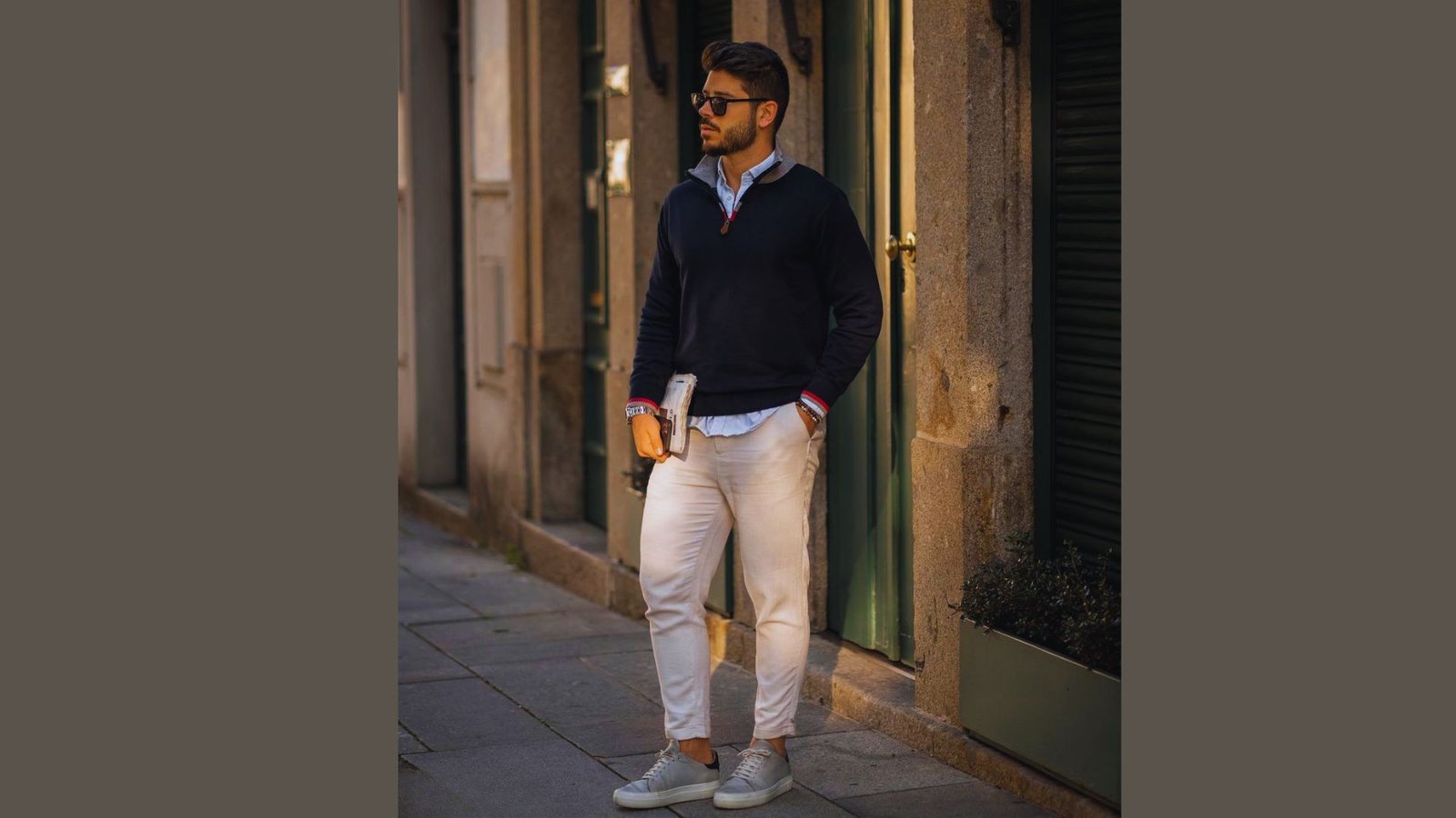  A man in a blue sweater and white pants is depicted, representing a casual and contemporary style.