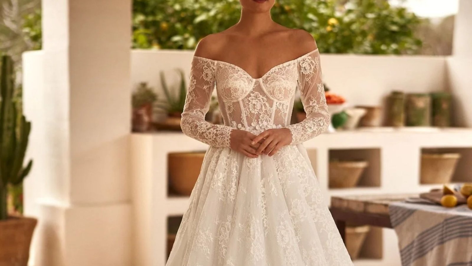 Elegant wedding dress featuring long sleeves and intricate lace detailing.