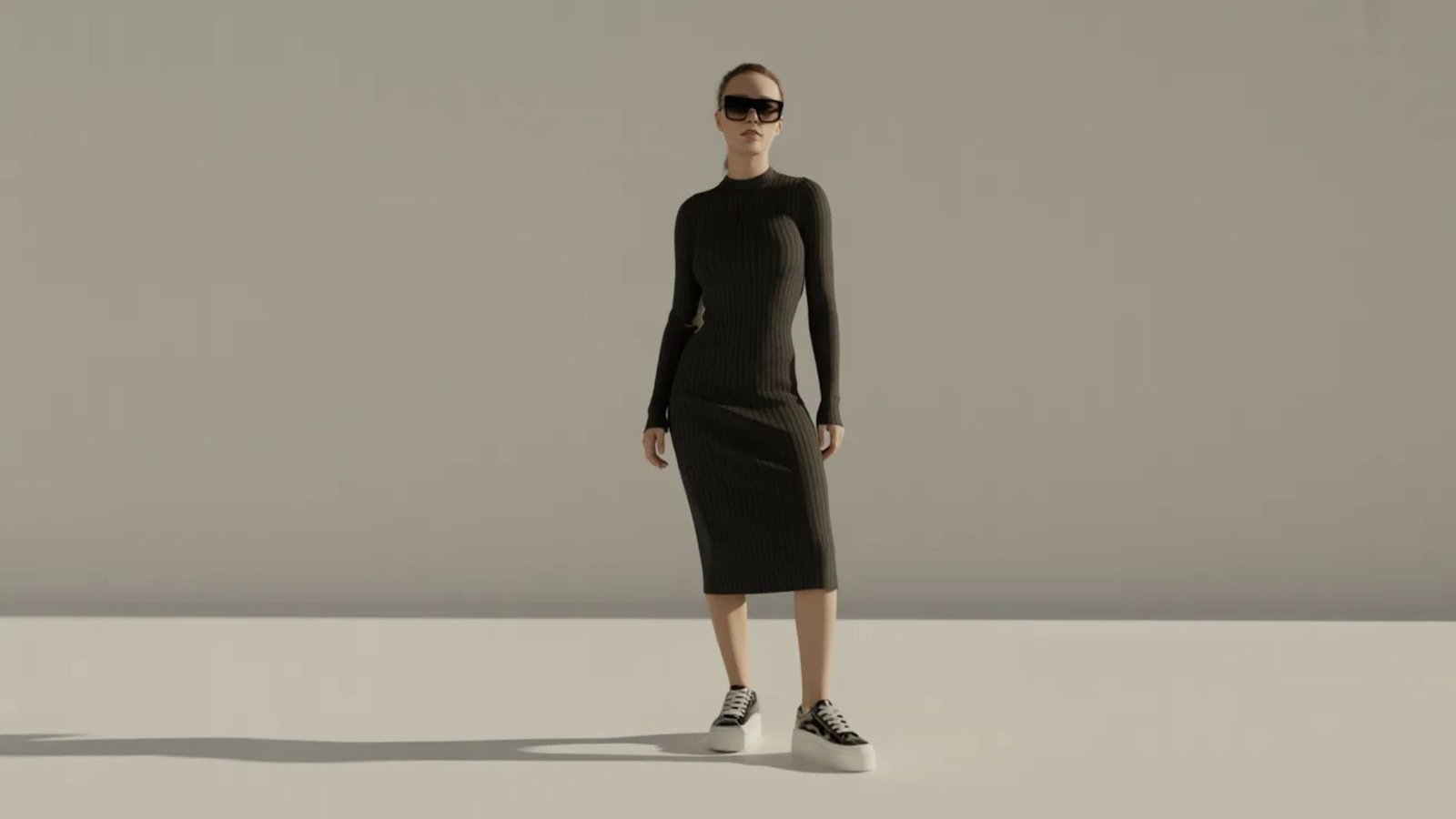 A woman wearing a black dress and sunglasses stands confidently, exuding elegance and style.