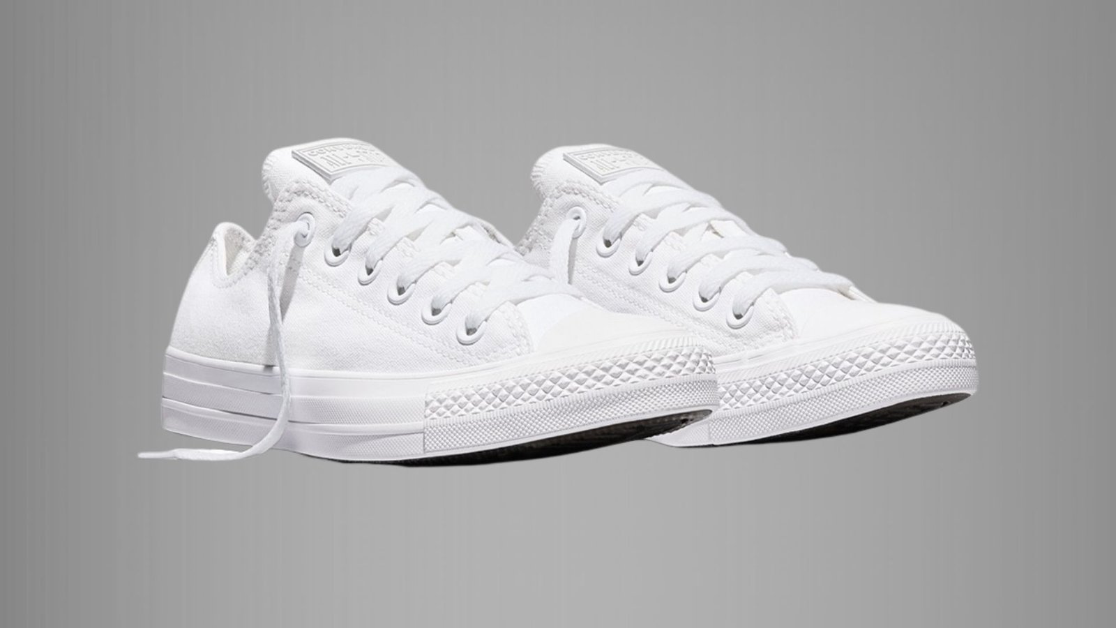 White Converse All Star Ox sneakers showcasing a timeless low-profile design and signature star emblem.