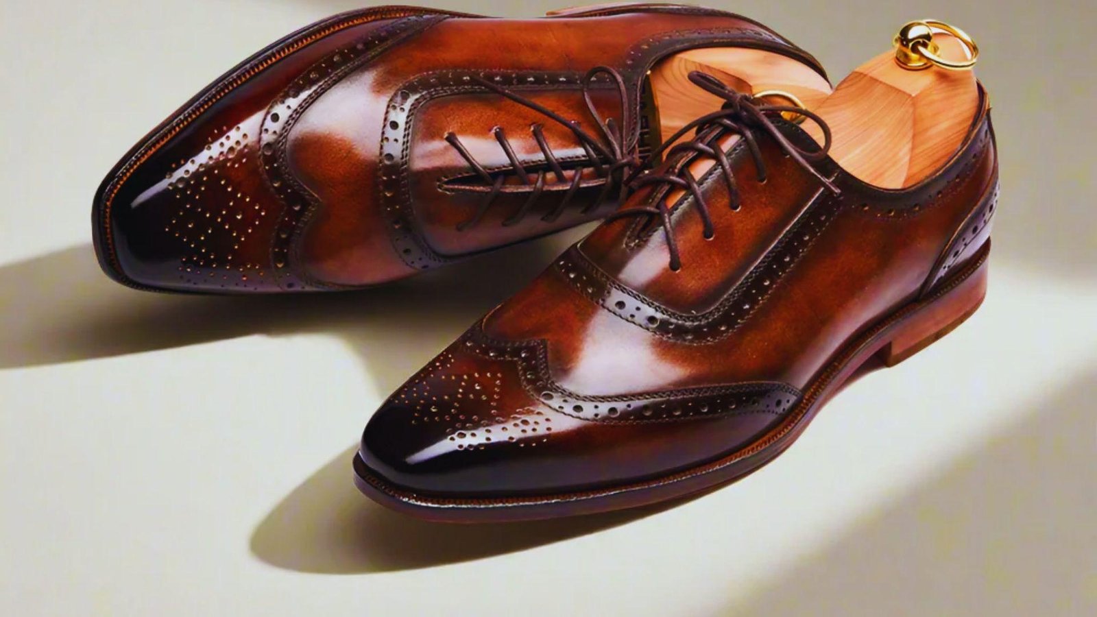 A pair of brown shoes featuring a matching brown sole, displayed from a top-down perspective.