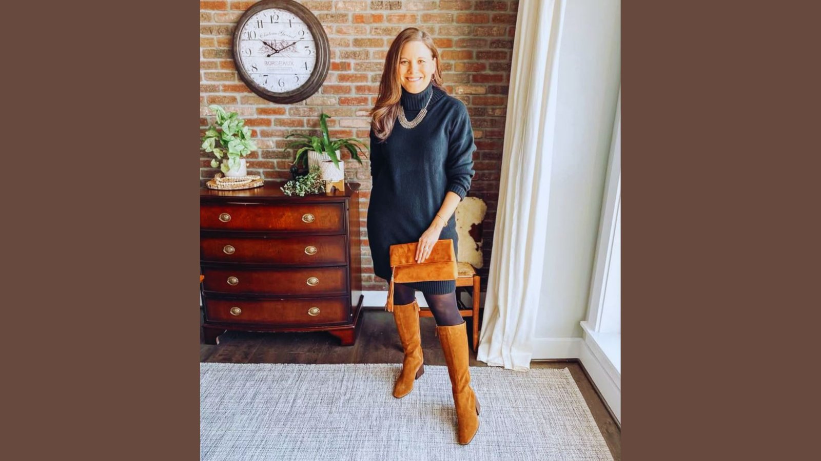 A woman wearing a black dress and boots strikes a pose for a photograph, exuding elegance and confidence.