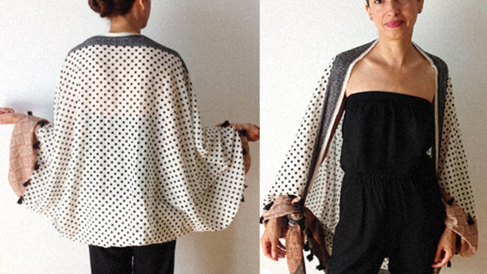 A woman wearing a black and white polka dot dress paired with a white and black poncho stands confidently.