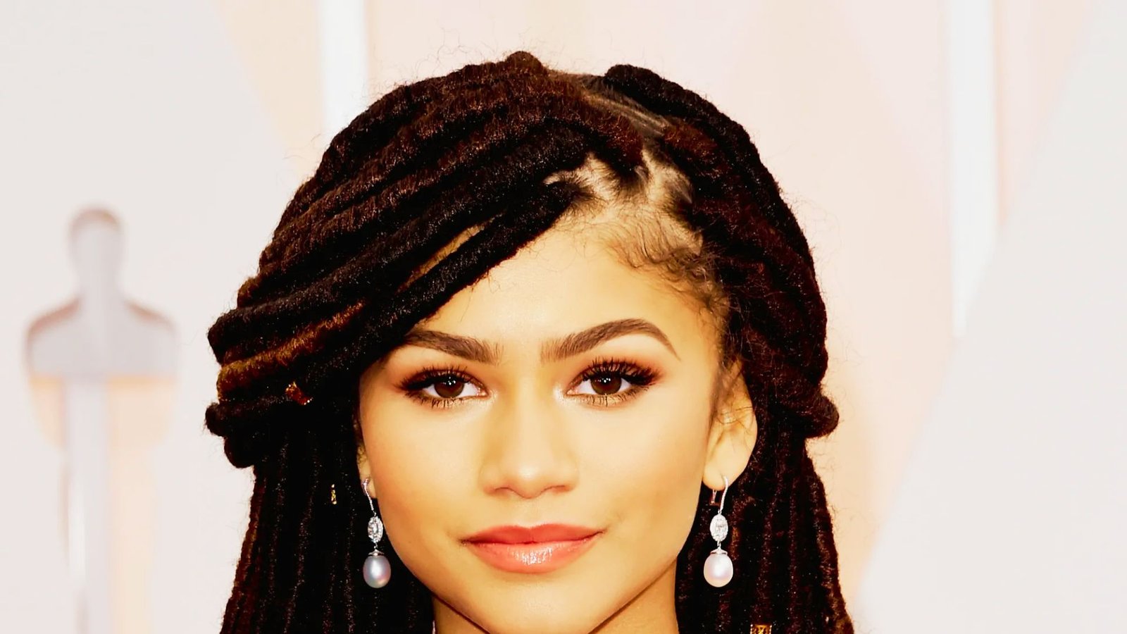 A woman with dreadlocks, showcasing a stylish look for faux locs ideas.
