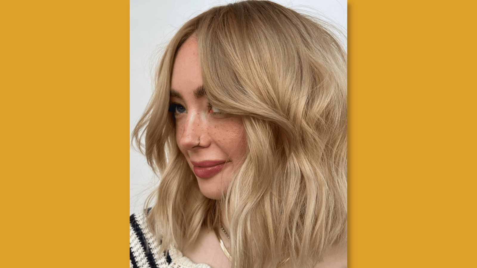  Low maintenance wavy medium length haircut with deep side part and soft layers on blonde hair for round 
