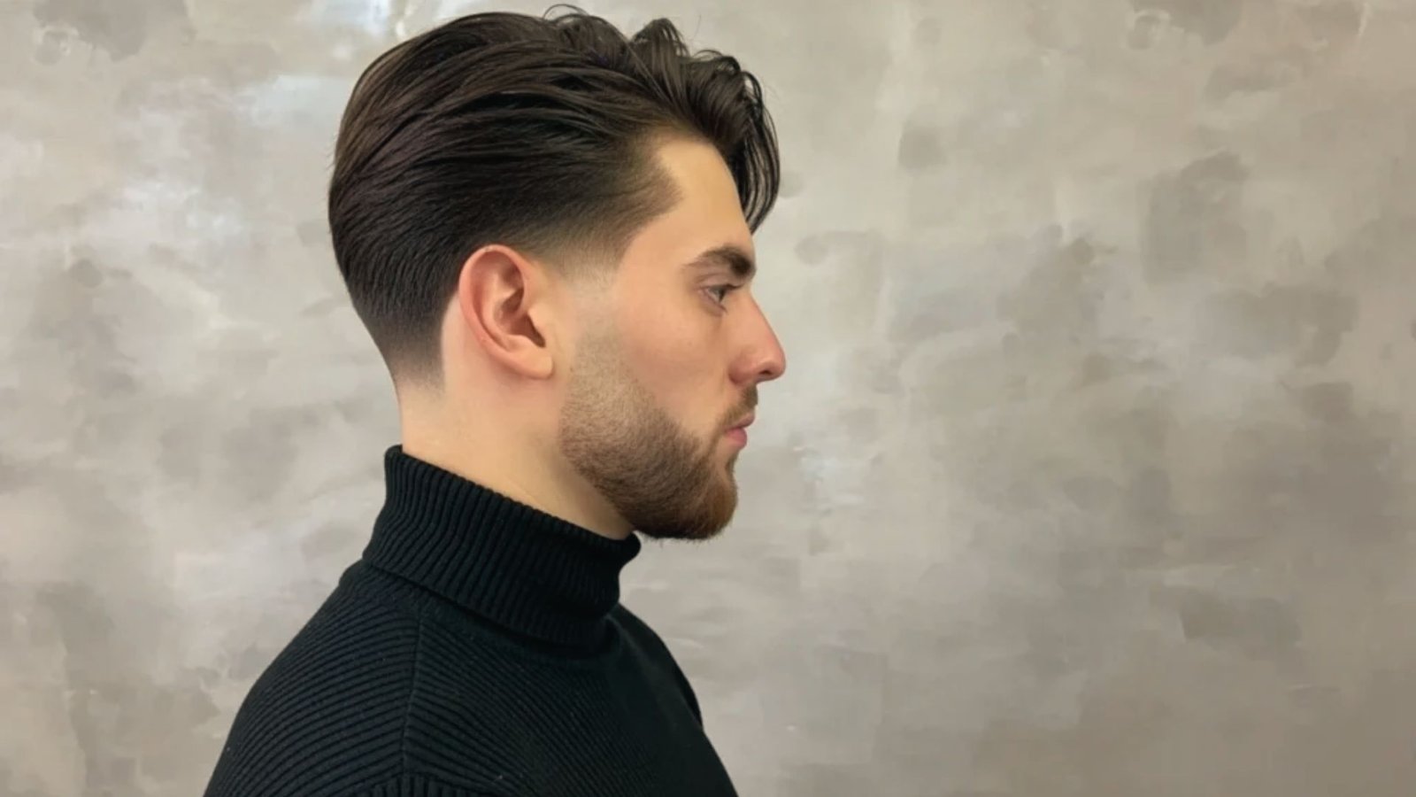 A man with a pompadour disconnected undercut fade hairstyle wearing a stylish turtle neck.