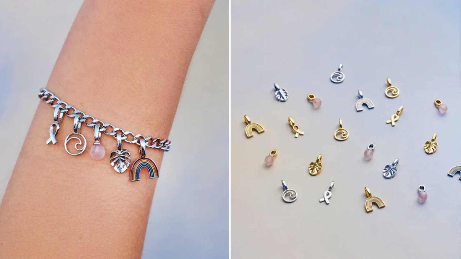 A silver charm bracelet on a wrist features a rainbow, leaf, and pink bead. Next to it, a selection of charms in gold and silver are displayed on a light surface.