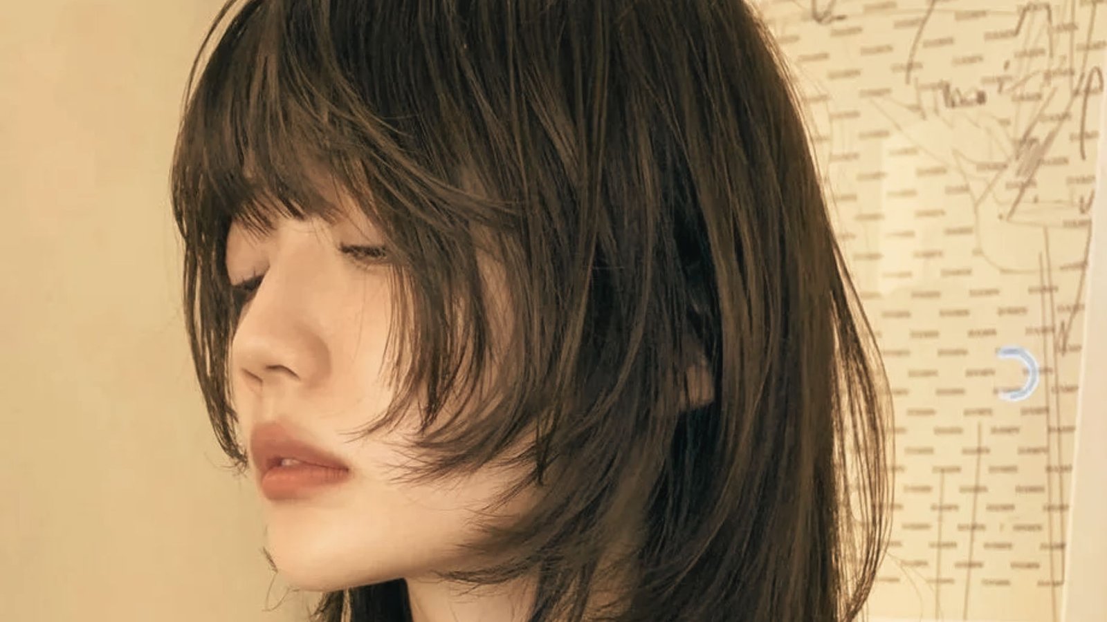 A woman with long hair styled in a Korean-influenced mullet.