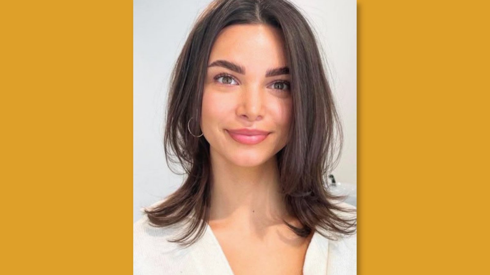  Low maintenance layered medium length lob with center part and flipped face-framing ends on dark brown hair for round face 
