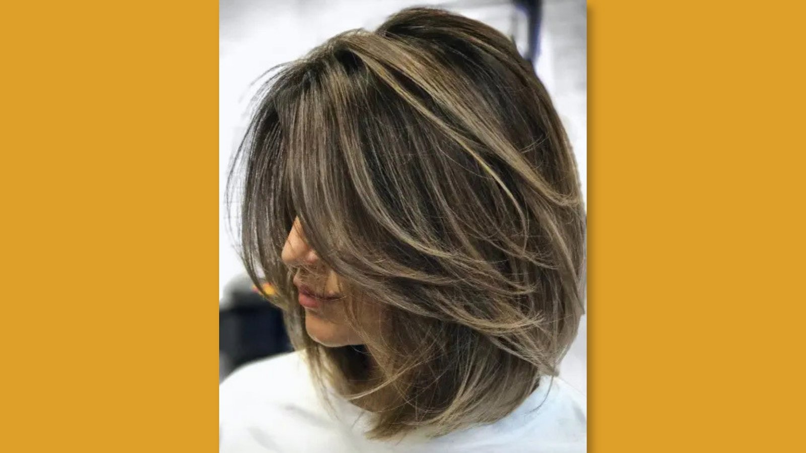 Side view of low maintenance layered medium length bob with choppy face-framing layers and dimensional highlights on light brown hair for round face
