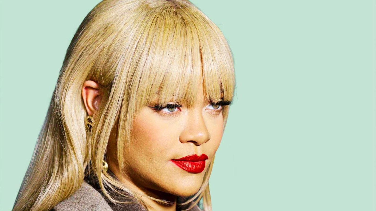 A womanshowcasing flared bangs and a stylish look.