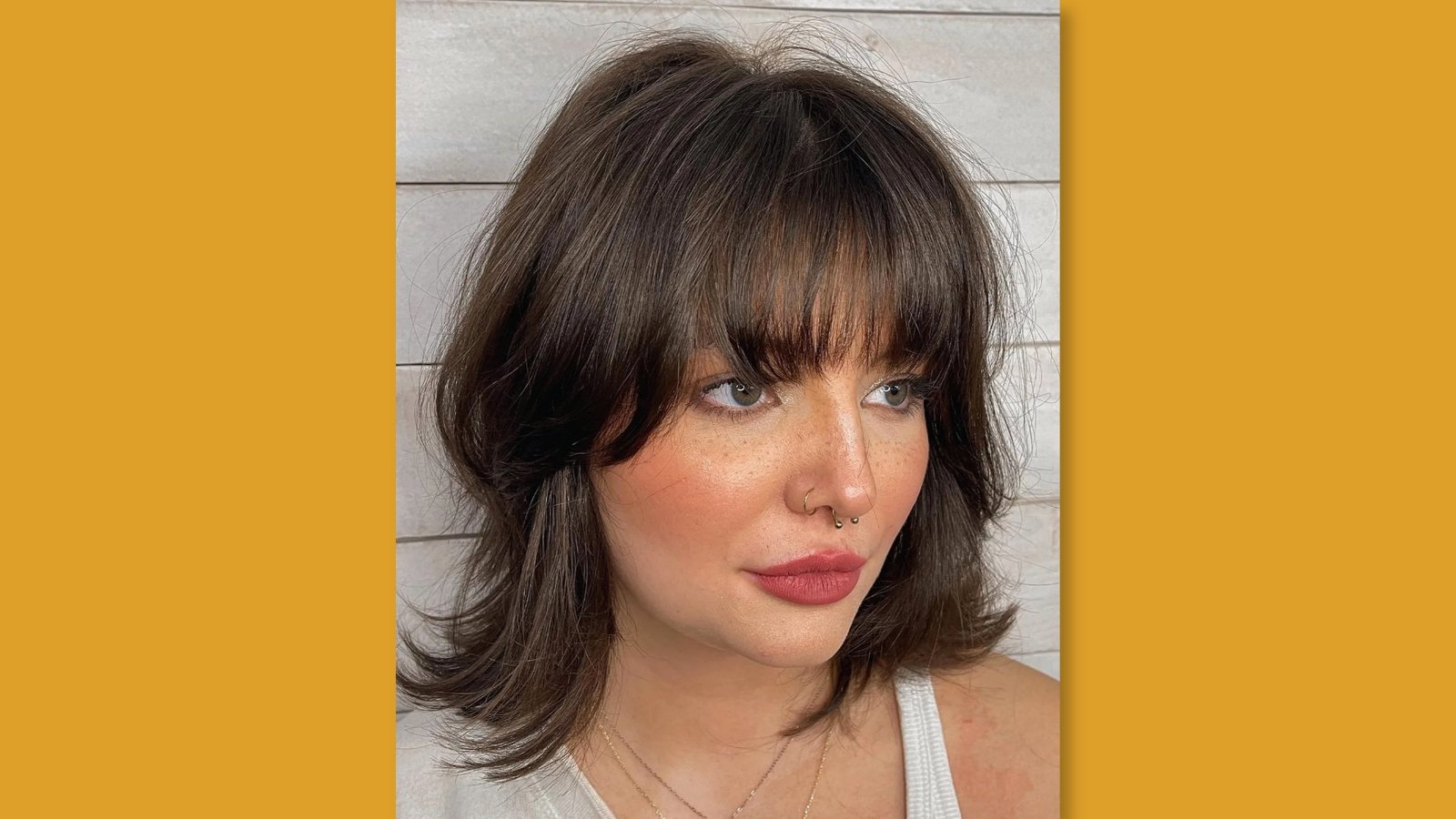  Low maintenance wavy medium length lob with side part and bright face-framing blonde highlights on brunette hair for round face 
