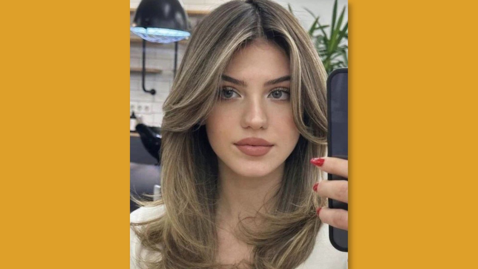  Low maintenance medium length layered hairstyle with voluminous curtain bangs and long face-framing layers on blonde balayage hair for round face
