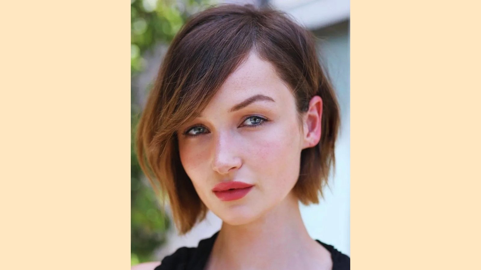 Brunette French bob with long side-swept bangs and soft layered ends at chin length