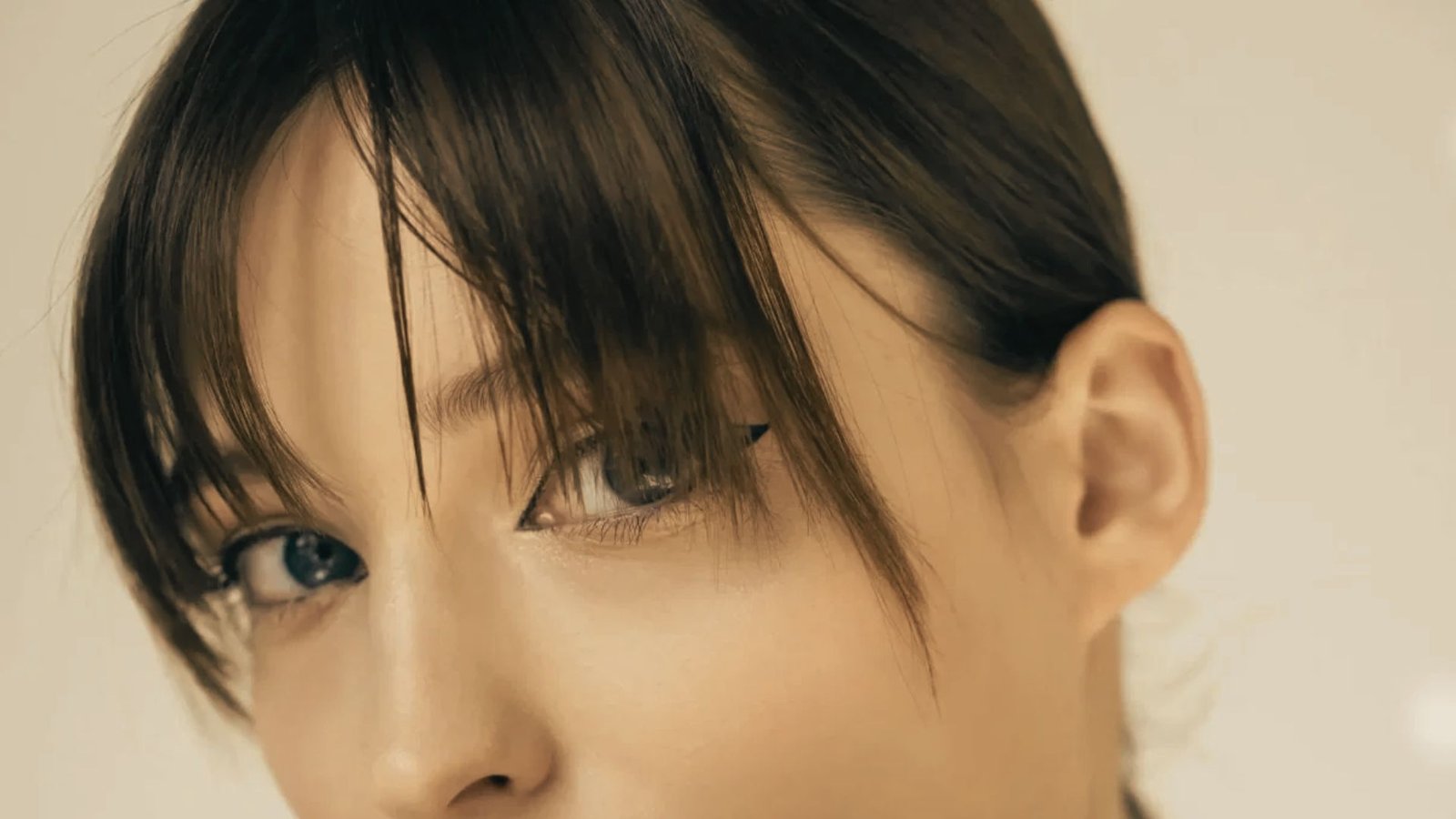 A woman with blue eyes and a short Micro Bangs Mullet hairstyle.