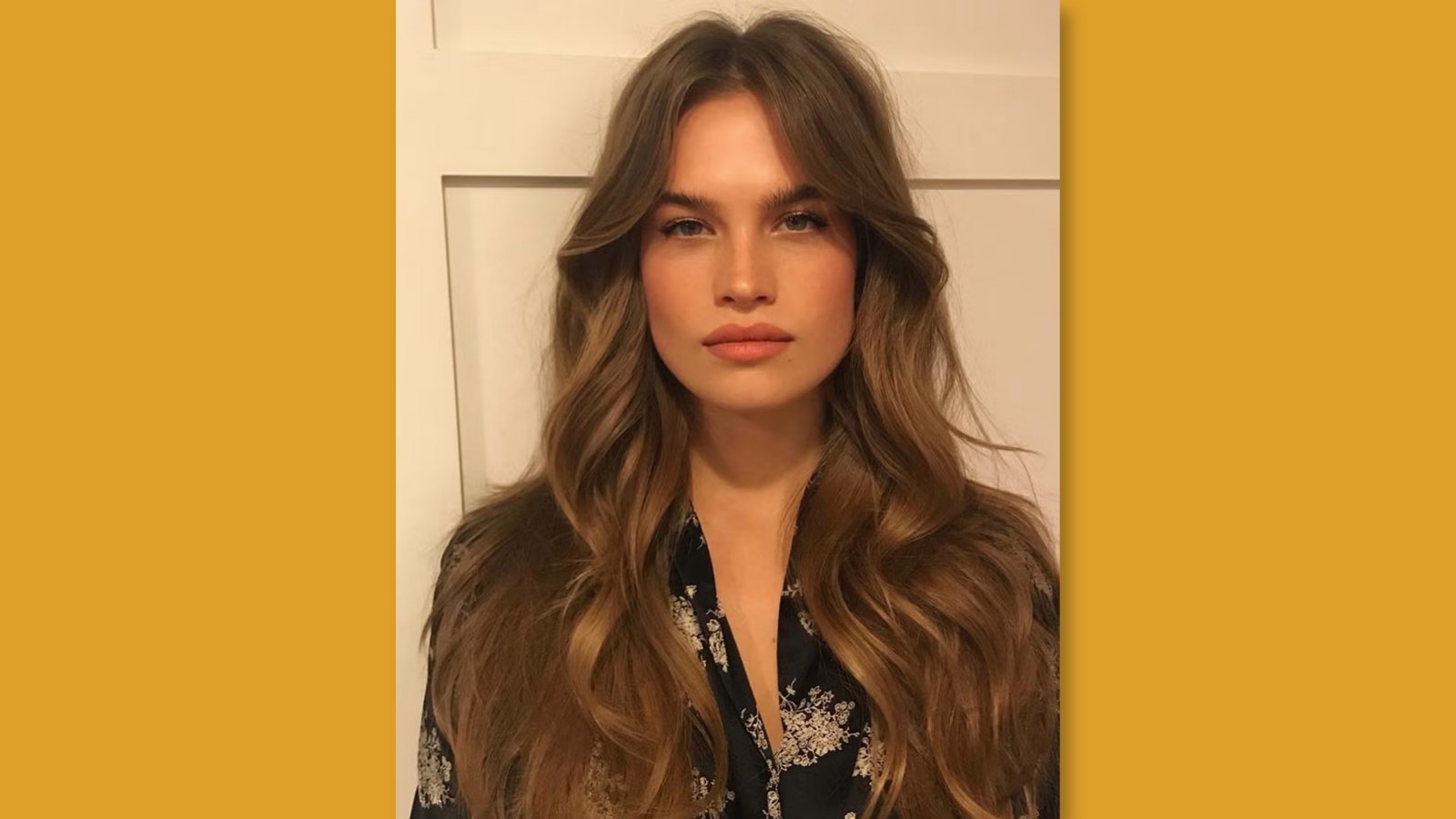  Low maintenance layered long hairstyle with soft curtain bangs and bouncy waves on light brown hair for round face 