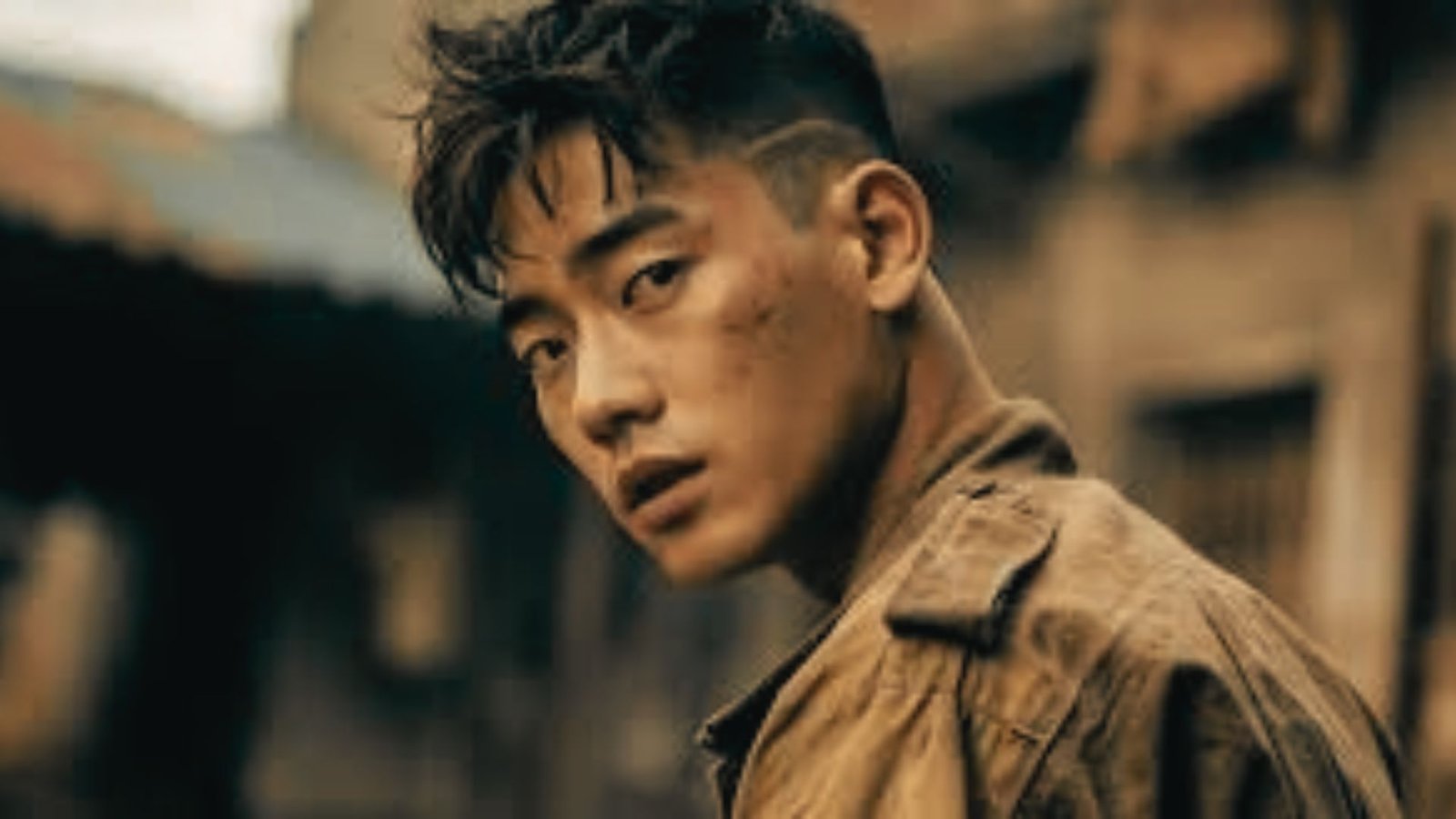 A man with a Korean fringe disconnected undercut fade gazes directly at the camera in a movie scene.