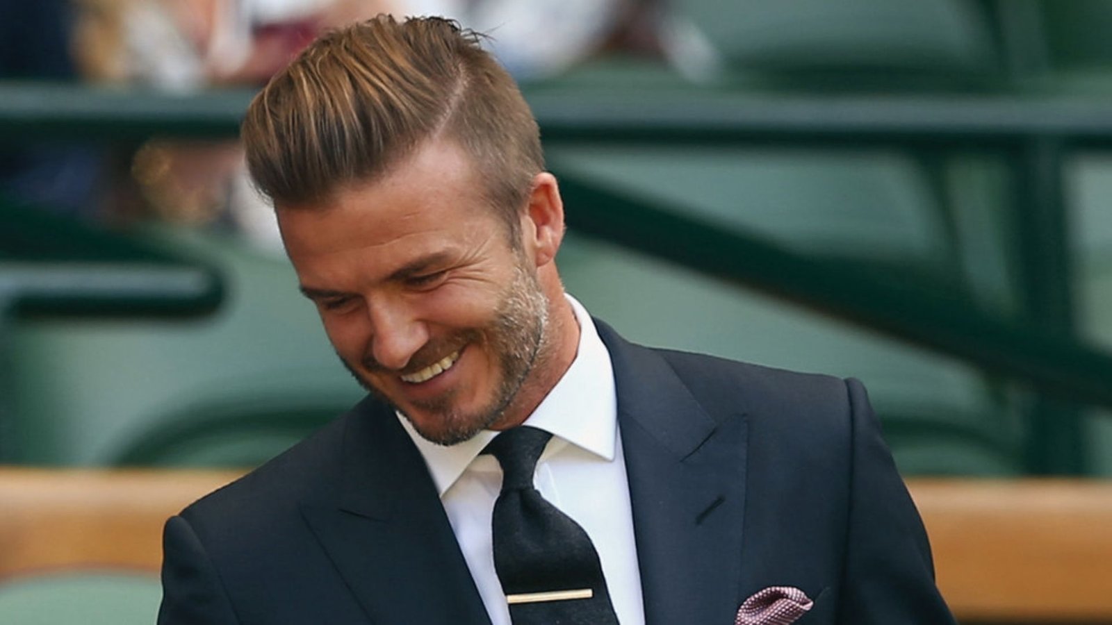 A man showcases a stylish side part disconnected undercut fade haircut, marking a significant improvement in his look.