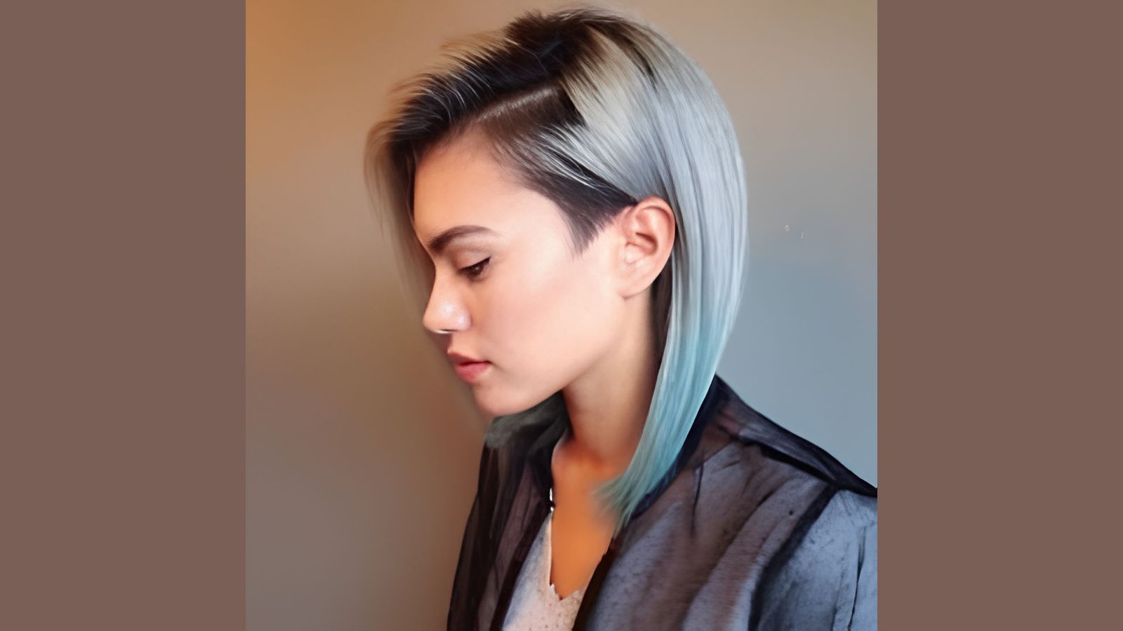 Side profile of a woman with a sleek silver-to-blue ombre bob featuring a hidden undercut. The long straight top layer contrasts with the shaved side section near the ear for a modern look.