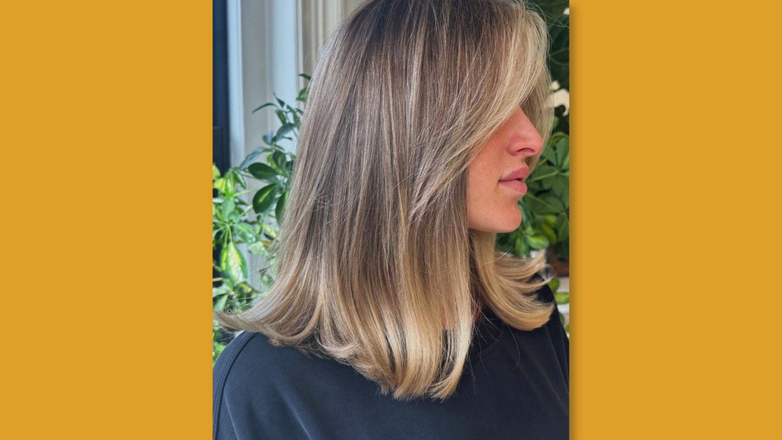 Low maintenance straight medium length layered haircut with deep side part and bright face-framing blonde highlights for round face 
