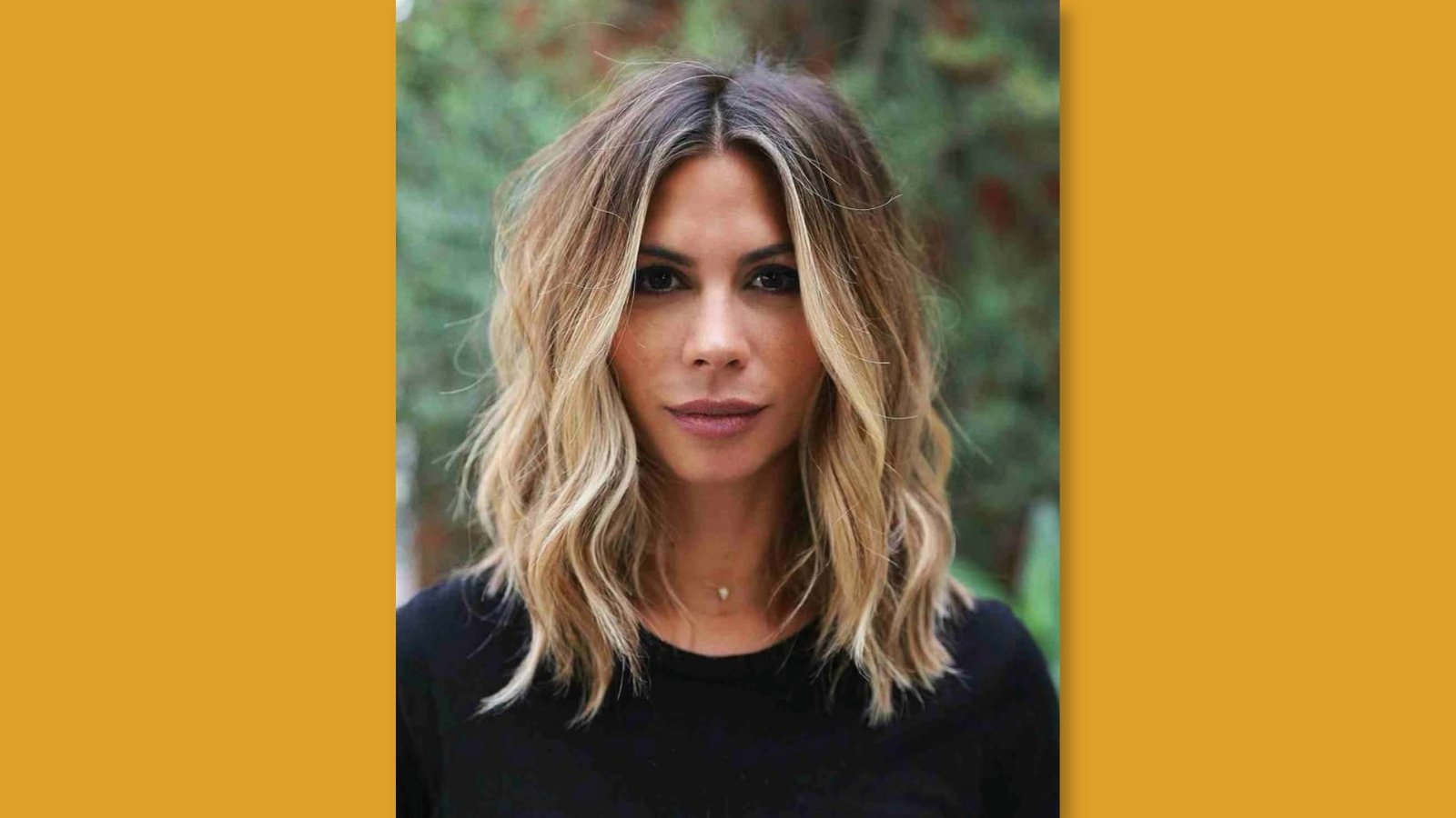  Low maintenance wavy medium length layered haircut with center part and subtle face-framing layers on blonde highlighted hair for round face
