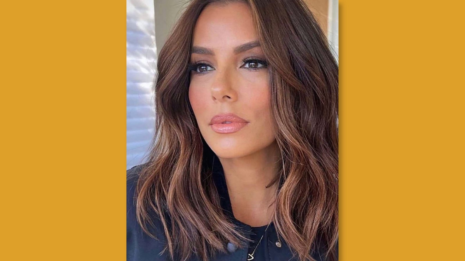  Low maintenance wavy medium length layered haircut with center part and soft face-framing layers on brunette hair for round face 