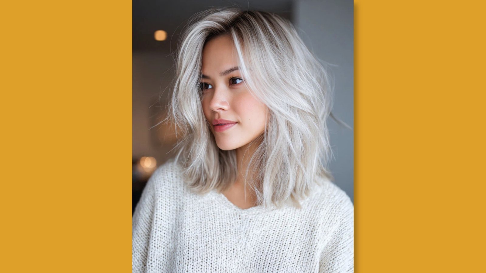 Low maintenance layered medium length shag with tousled texture and soft curtain bangs on platinum blonde hair for round face 

