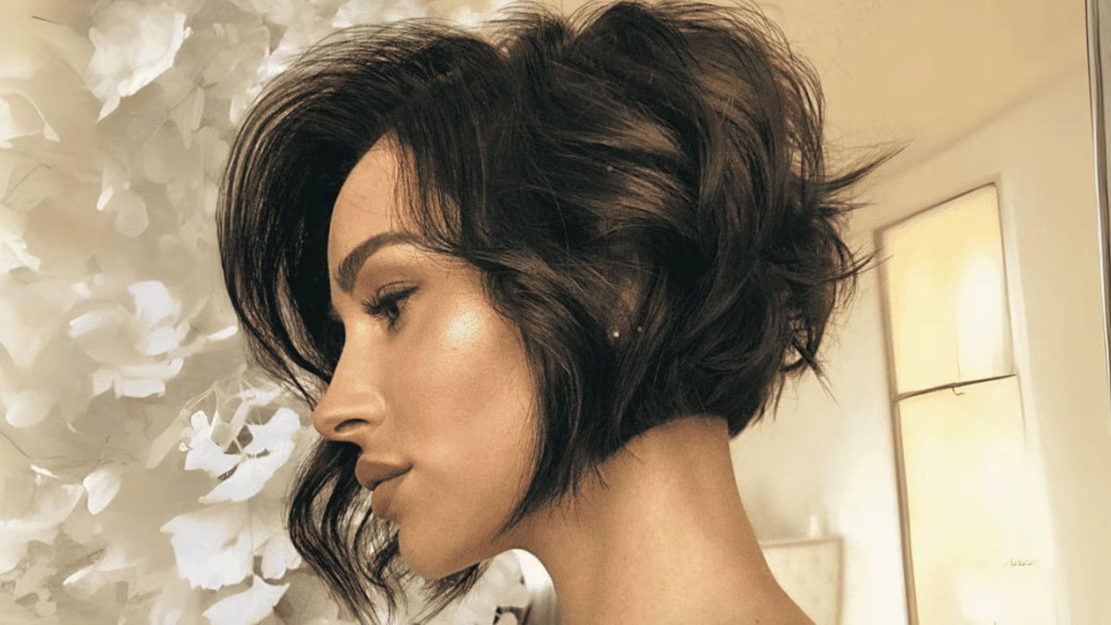 A woman with a short hair cut showcasing her low maintenance curly pixie style