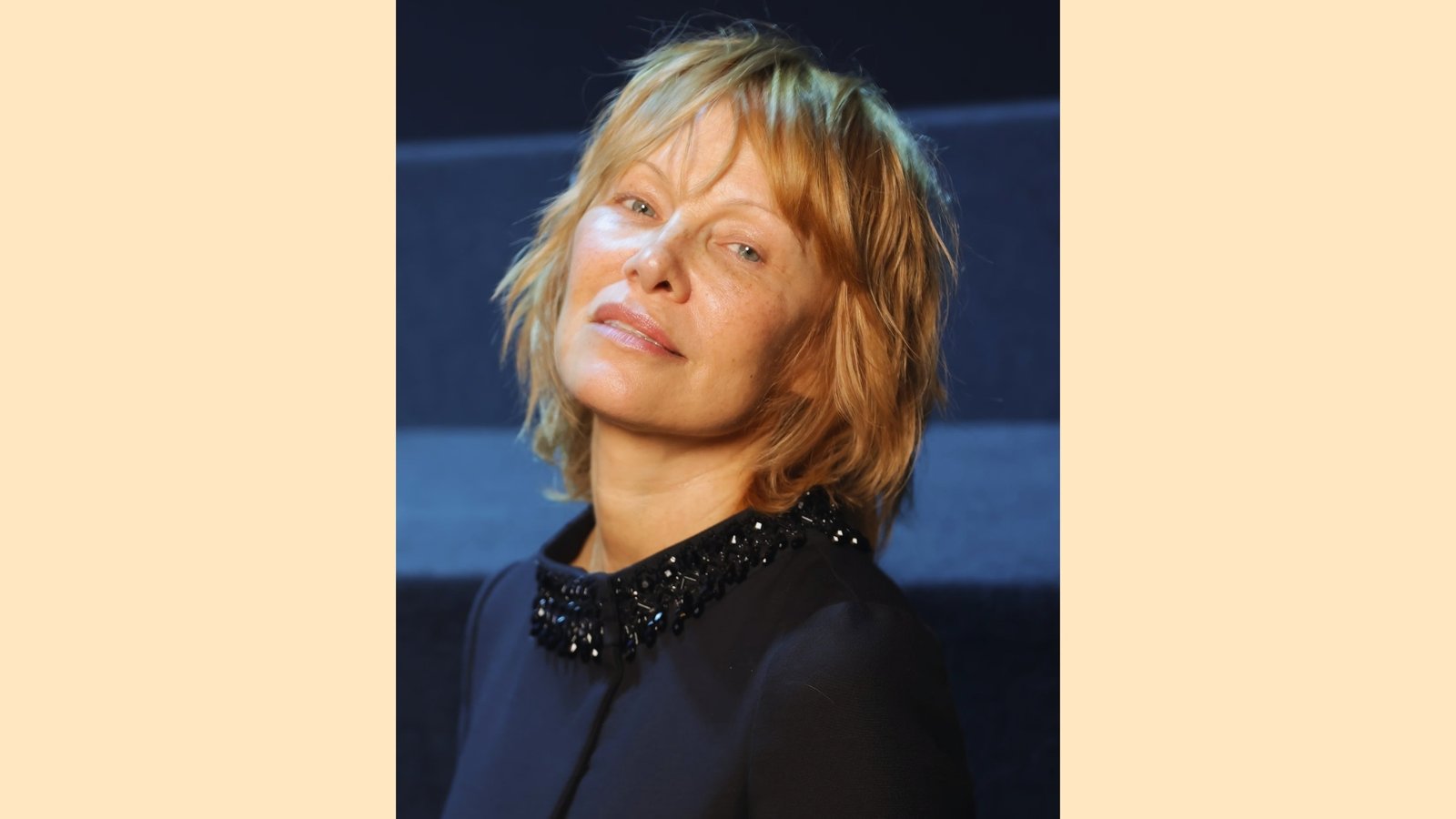 Shaggy strawberry blonde French bob with wispy bangs and layered chin-length shape