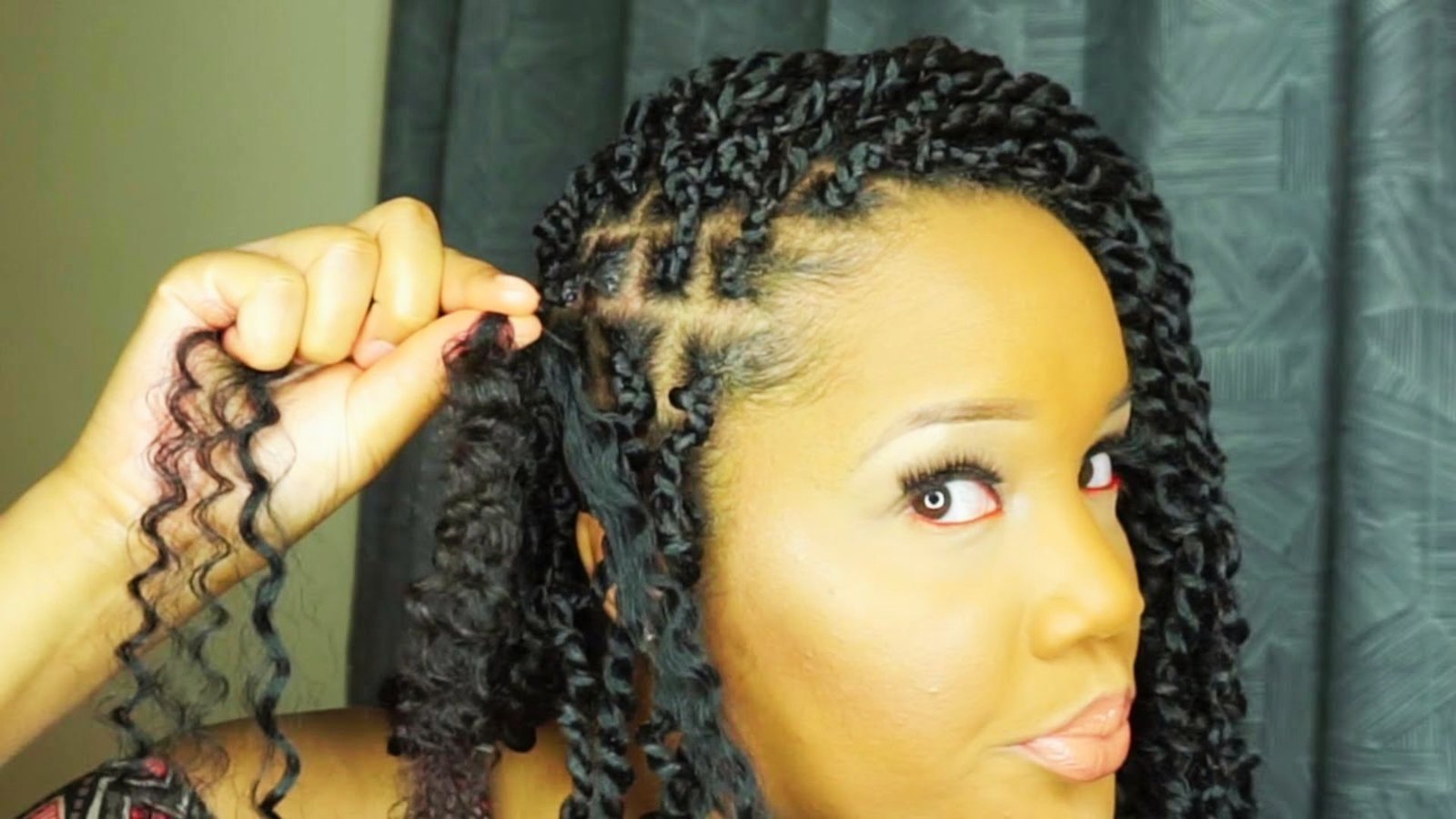 A woman adding hair extensions while twisting her hair, demonstrating Step 3 of a Senegalese twists tutorial.