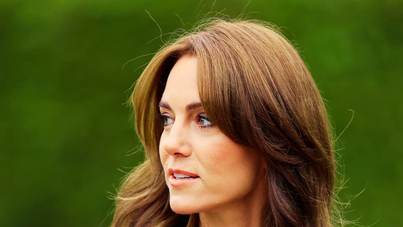 A woman with long hair styled with butterfly bangs, showcasing a trendy hairstyle option for various face shapes.
