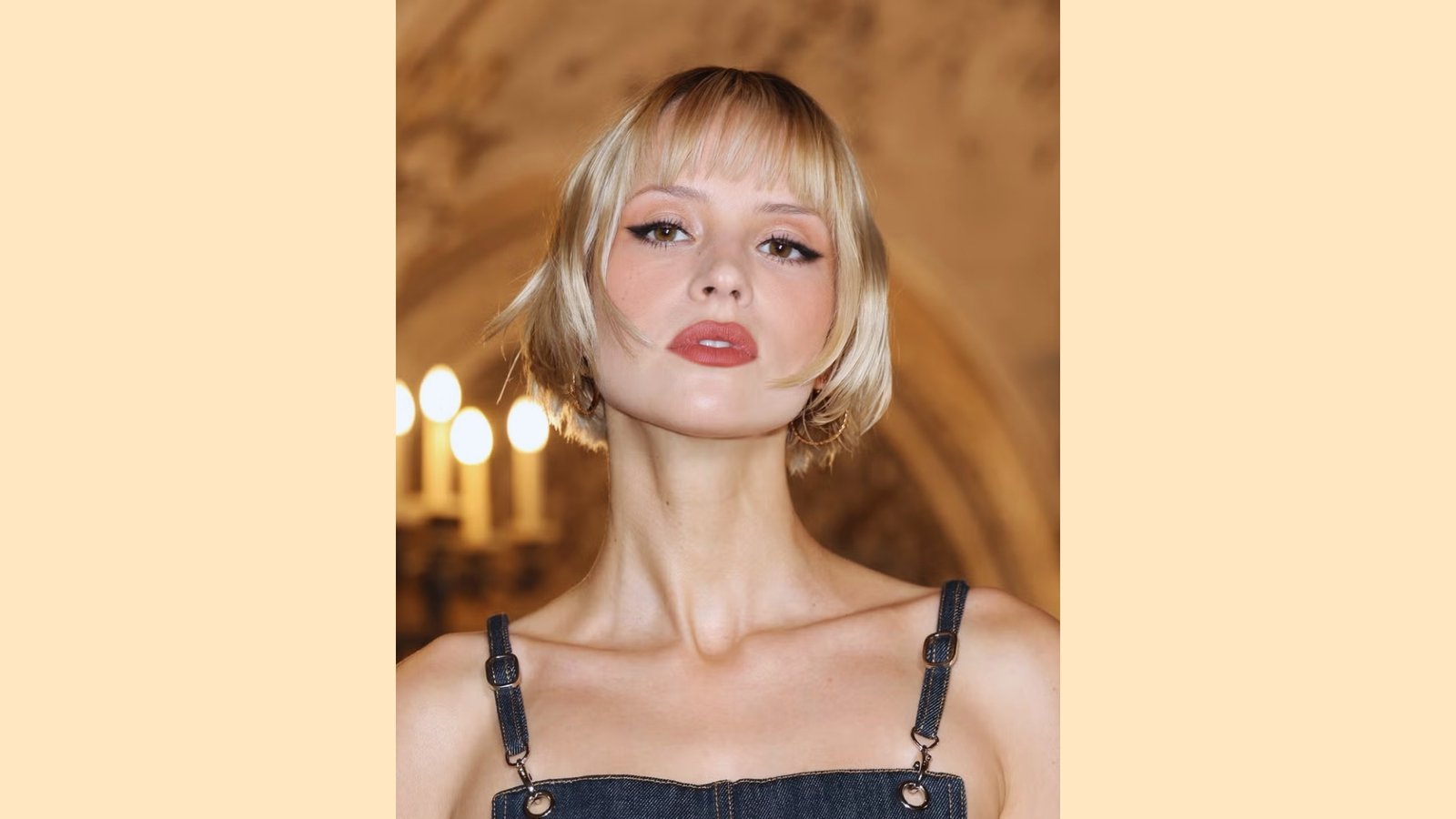 Classic blonde French bob with blunt micro bangs and sharp jaw-length cut, high-fashion editorial style