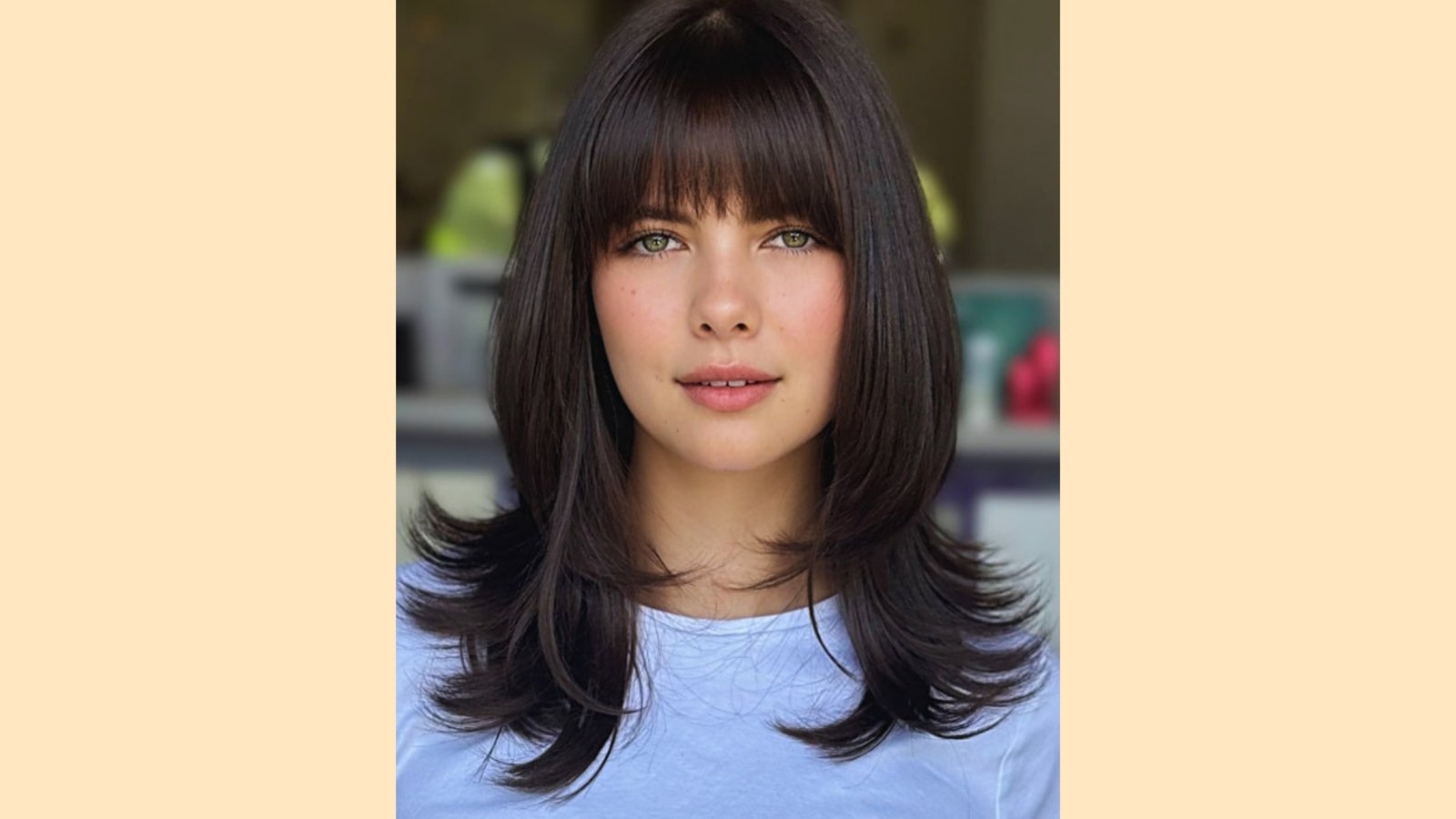 Medium length straight dark brown hair with wispy curtain bangs and flipped face-framing ends