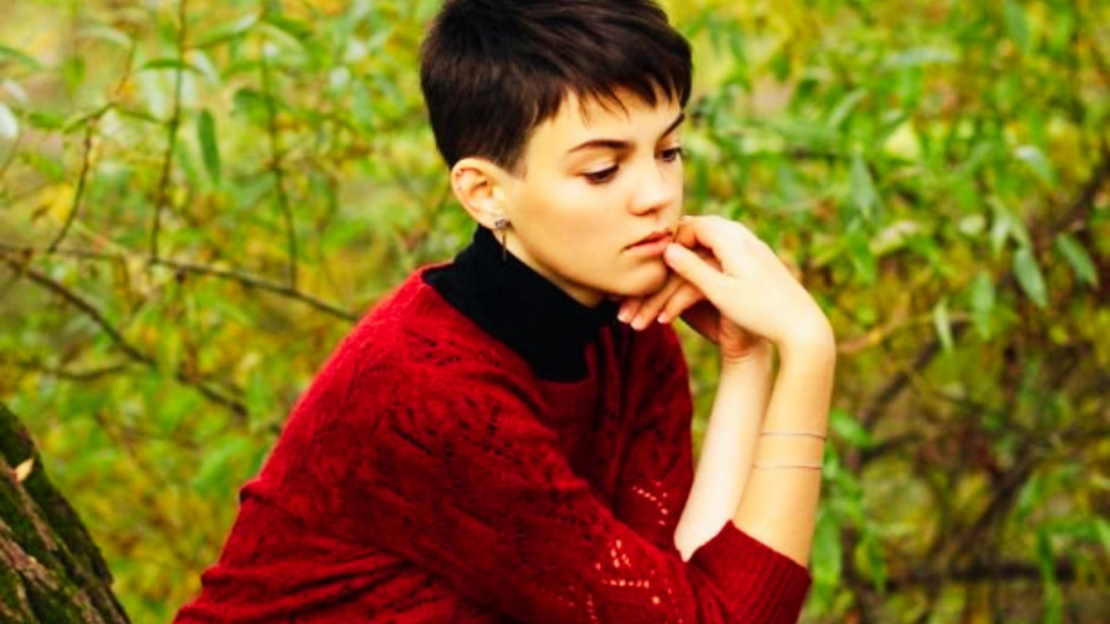 A woman with short black hair showcasing a how the Edgy Messy Short Pixie Cut Works