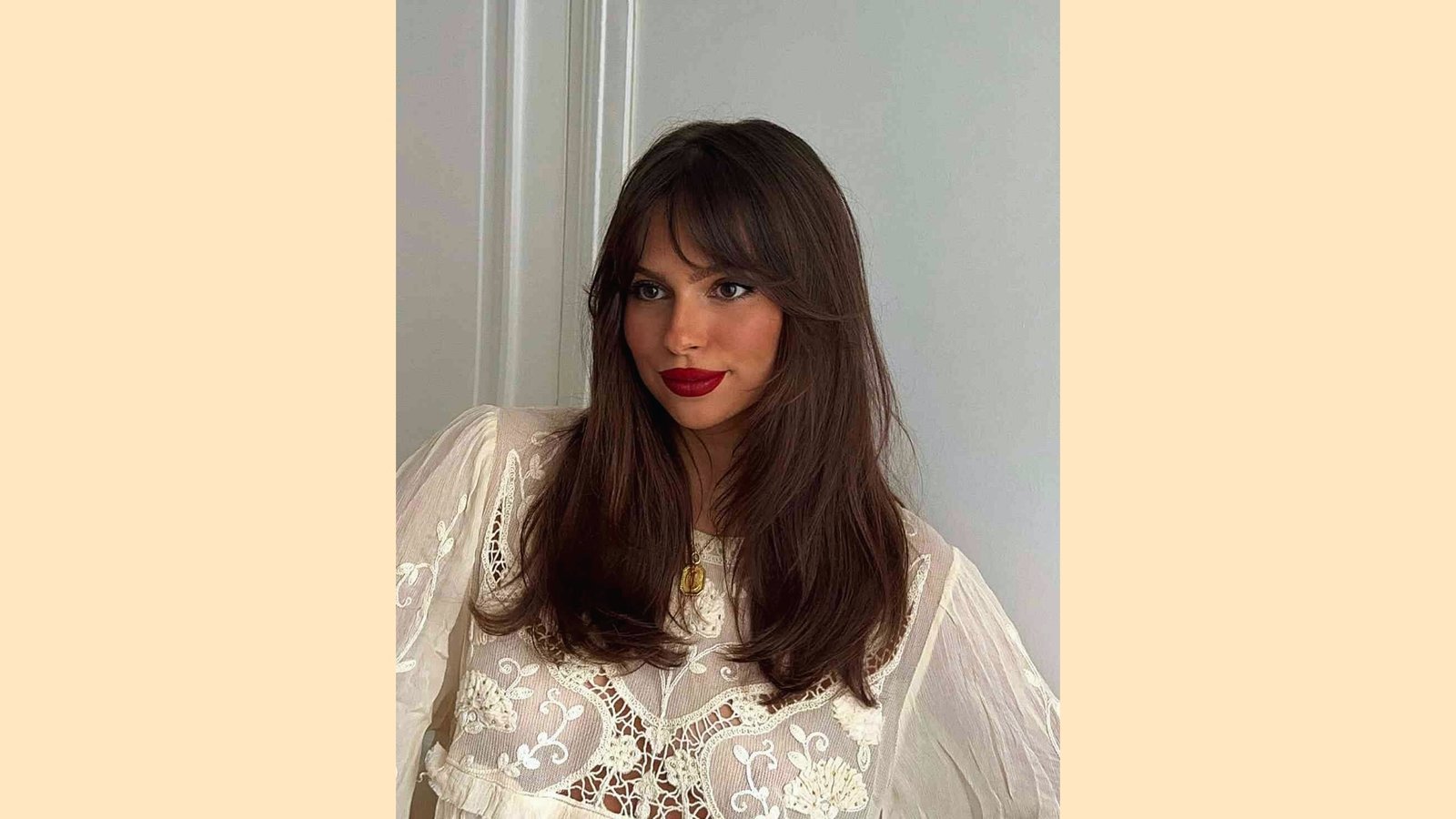 Long straight dark brown hair with wispy curtain bangs and subtle face-framing layers