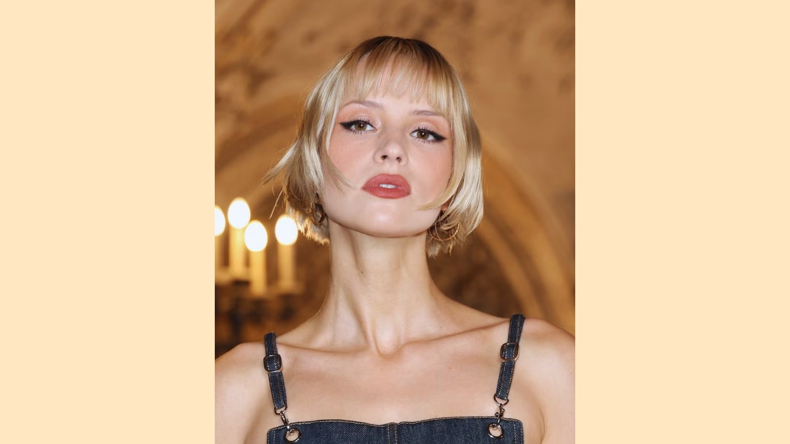Blonde chin-length bob with wispy see-through curtain bangs and straight face-framing layers