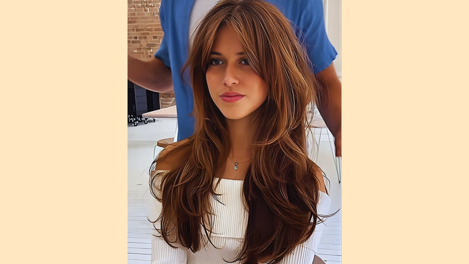 Long voluminous layered hair with wispy curtain bangs and soft waves on dimensional brunette hair