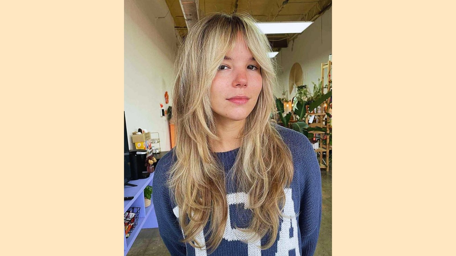 Long layered blonde shag haircut with wispy curtain bangs and tousled choppy texture