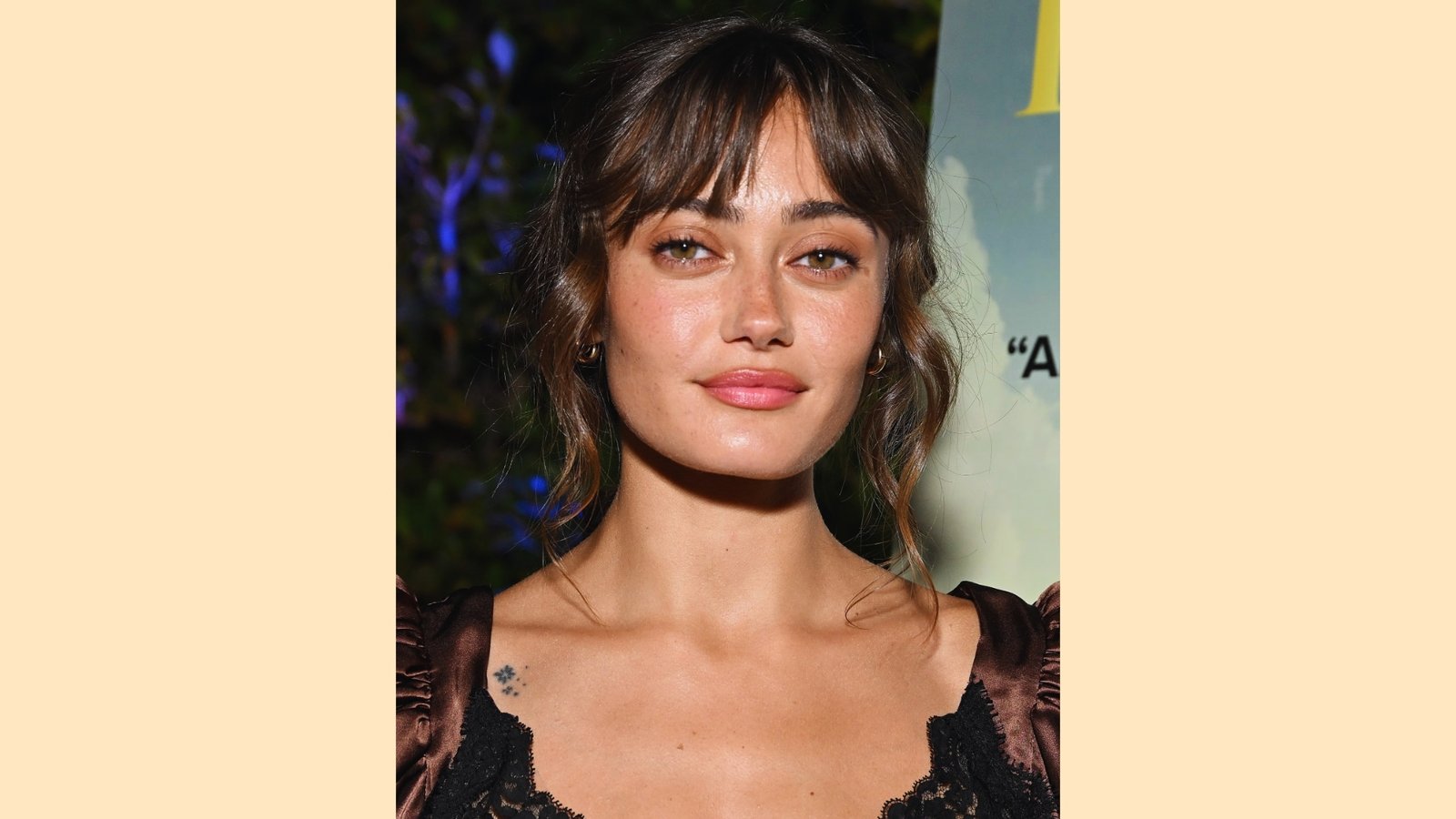 Wispy curtain bangs with soft waves on a medium length brunette hairstyle, loose tendrils framing the face